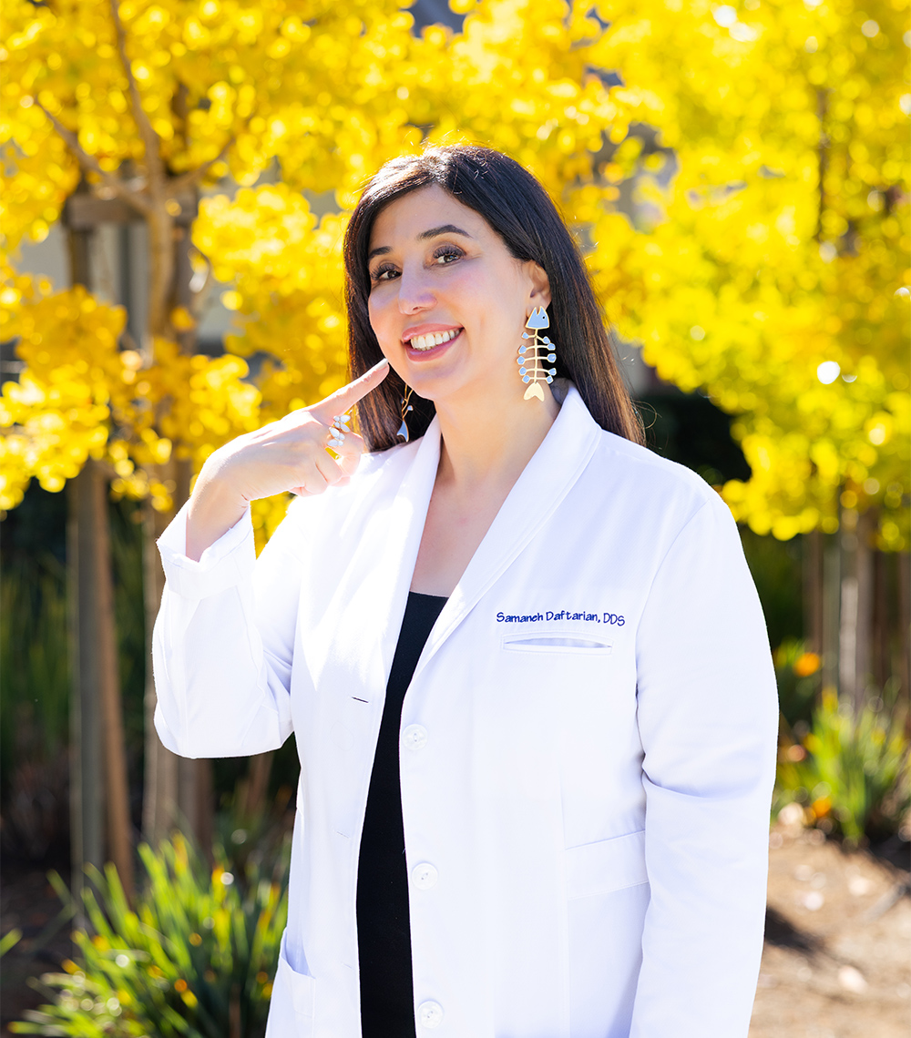 Smiling Dr. Samaneh Daftarian in a white coat highlighting cosmetic dental care in the Palo Alto community
